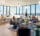 Sofas and chairs in a living room, with people sitting and talking.