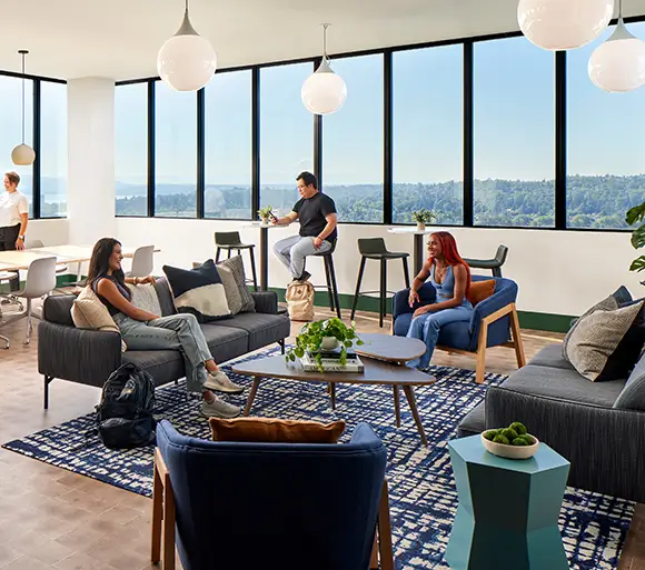 Sofas and chairs in a living room, with people sitting and talking.