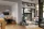 Sofas and chairs in a living room, with people sitting and talking.